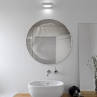 Round LED mirror with 3D effect for a modern touch.